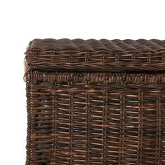 a brown wicker basket with handles on white background