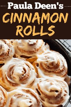 cinnamon rolls in a cast iron skillet on a cooling rack with the words, paula deen's cinnamon rolls