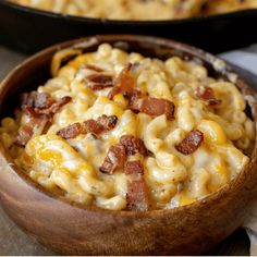 a wooden bowl filled with macaroni and cheese