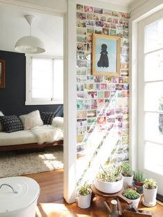 a living room filled with furniture and pictures on the wall behind it's windows