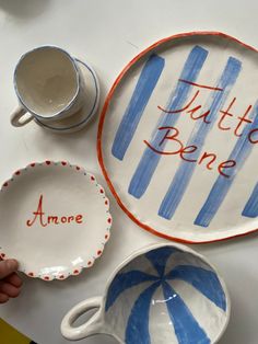 two hand painted plates with words on them, one has a candy cane and the other is a bowl