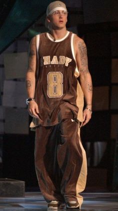 a man in a basketball uniform is walking down the runway with his hands on his hips