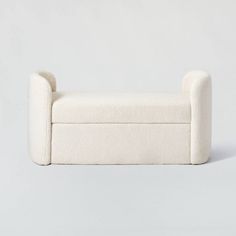 a white couch sitting on top of a gray floor