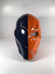 "Disclosure: this is not an official DC comics or Warner Bros. product, but only a replica for sale for cosplay and collectibles. This is a fan-made representation and in no way affiliated or licensed by DC Comics. Deathstroke Arkham Origins mask and back plate. Mask comes painted. Listing is for Midnight Navy Blue and True Orange as shown in pics. No 3D Print Lines. Made out of PLA plastic, primed and filled so it's very durable. I offer the mask in any color and I have quite a few listed: Gunm Deathstroke Mask, Deathstroke Cosplay, Red Hood Helmet, Orange Costume, Dc Costumes, Jason Todd Batman, Arkham Origins, Robin Comics, Dc Comic Costumes