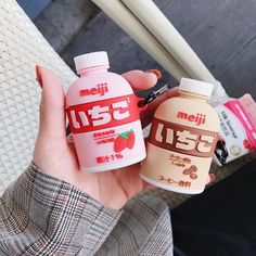 a person holding two different types of food in their hands, one is brown and the other is pink