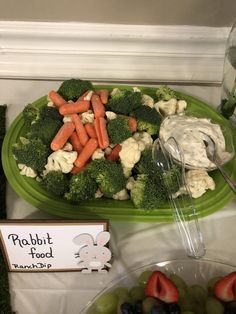 there is a platter of vegetables and fruit on the table