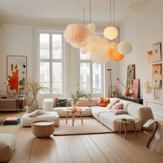 a living room filled with white furniture and lots of lights hanging from the ceiling above