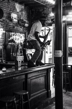 a man riding a bike on top of a bar