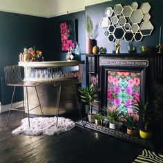 a living room filled with lots of furniture and decor on top of a hard wood floor