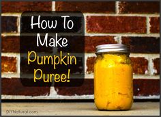 a jar filled with pumpkin puree sitting on top of a table next to a brick wall