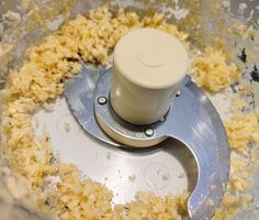 a food processor filled with yellow rice in it