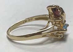 Pretty ESTATE 14K Yellow Gold Marquise Gemstone and Diamond Ring Size 6.25 Very pretty and unique ring! * 2.5 grams * Size 6.25 * 14k Yellow Gold with assorted marquise cut gemstones - blue topaz, citrine and garnet and small round genuine diamond accents! * Shipped in a gift box Please message me with any questions I guarantee item to be exactly as described and pictured. Gold Multi-stone Cluster Ring Collectible, Collectible Cluster Gemstone Rings, Gold Cluster Ring With Birthstone, Gold Birthstone Cluster Ring, Collectible Yellow Gold Cluster Ring With Gemstone, Gold Multi-stone Pear-shaped Ring, Gold Three Stone Gemstones For Anniversary, Gold Cluster Birthstone Ring With Gemstone, Black Opal Pendant