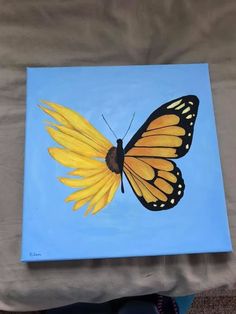 a painting of a yellow butterfly on a blue background