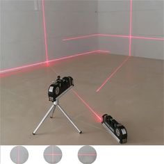 a camera is on a tripod in front of a wall with pink lasers