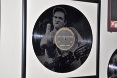 an elvis presley record is framed in black and white