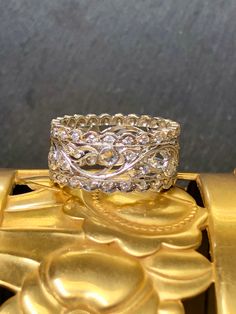 A very well done band crafted in platinum with great attention to its milgrain detail. It has been set with both round and rose cut diamonds being G-H color and Vs1-2 clarity diamonds. Total approximate weight is .90cttw. Dimensions/Weight: Ring measures .40"/8.8mm and weighs 5.8g. Size 6 (not sizable). Condition: All stone are secure in almost unworn condition. R-TUH Wide Band Ring, Wide Band Rings, Well Done, Rose Cut Diamond, Wide Bands, Rings Statement, Rose Cut, Band Ring, Band Rings