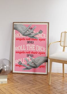 a pink poster with the words roll the dice on it in front of a chair