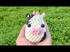 a small crocheted animal that looks like a zebra with pink flowers on its head