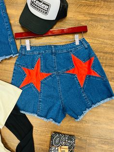 Rock the rodeo or the concert scene with these vintage-style denim shorts featuring red stars on the back. These Western vibes shorts exude a trendy and playful vibe, perfect for a fun night out. Plus, supporting a small business never looked so good! Yeehaw! Small 2-4 Medium 6-8 Large 10-12 Spring Cotton Shorts With Star Print, Cotton Star Print Shorts For Spring, Cotton Shorts With Star Print, Cotton Star Print Shorts, Trendy High Waist Jean Shorts For Festival, Trendy Cotton Jean Shorts For 4th Of July, High Waist Bottoms For Summer Music Festival, Trendy Cotton Jean Shorts With Star Print, Trendy Jean Shorts For Festivals