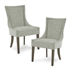 two chairs sitting side by side in front of a white background and one has a light colored upholstered back