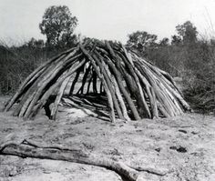 a pile of sticks sitting on top of a dirt field