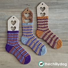 two pairs of socks with hearts on them and a bottle opener hanging from the side