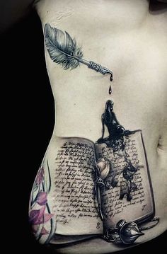 a woman's stomach with an open book, feather and ink pen on it