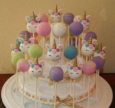 there is a cake decorated with unicorns on the top and candy in the middle