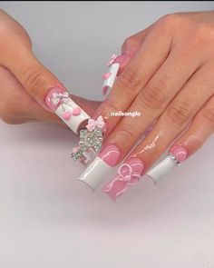 a woman's hands with pink and white nail designs