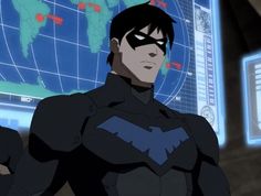 batman animated character standing in front of a computer screen with the world map on it