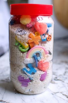 a glass jar filled with lots of toys