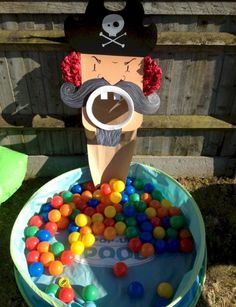 a birthday cake made to look like a pirate with lots of balls in the pool