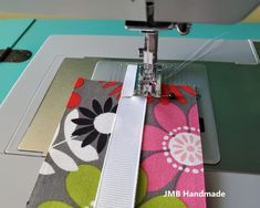 the sewing machine is working on some colorful fabric and it's needle being sewn