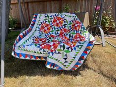 a quilted blanket sitting on top of a swing