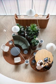 two people sitting at a table in the middle of a room with chairs and tables