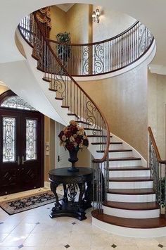 a staircase in a home with flowers on the table