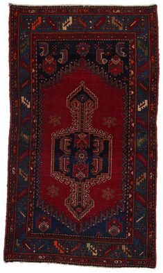 an antique persian rug with red and blue colors