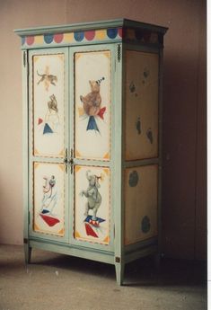 an old cabinet painted with animals on it