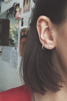 a close up of a person with ear piercings