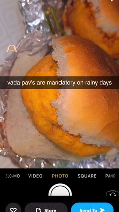 an image of some food that is on tin foil and has been edited to say, vada pav's are mandatory on rainy days