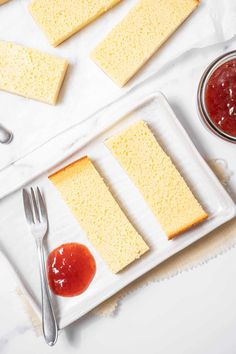 slices of sponge cake on a plate with ketchup and spoons next to it