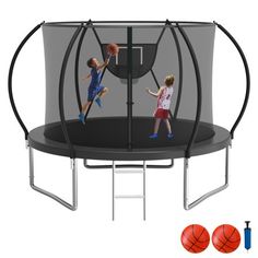 two young boys playing basketball in a trampoline