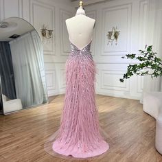 a mannequin is dressed in a pink dress with sequins on it