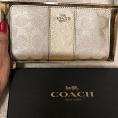 Brand New Beautiful Coach Wallet, Comes In Original Box. Priced To Sell. Send Me An Offer. $125 Gold Formal Bag With Interior Card Slots, Designer Gold Bifold Wallet, Compact Gold Wallet With Interior Card Slots, Coach Bifold Wallet As Gift, Compact Coach Wallet As Gift, Designer Gold Wallet With Card Slots, Designer Gold Wallets With Card Slots, Designer Gold Clutch For Daily Use, Coach Rectangular Formal Wallet