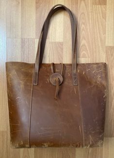 "Vintage Handmade Distressed Brown Leather Hobo Shoulder Bag Large Tote  Made in USA  Leather Strap Closure, Leather & Canvas Strap  Length 13\" x Width 5.5\" x Height 13\" Strap drop 10\" Condition is Used The exterior has some scuffs. The interior is in very good condition  This is a rare find. It has a beautiful rustic distressed leather look." Handmade Leather Casual Bag, Handmade Leather Casual Shoulder Bag, Handmade Brown Shoulder Bag For On-the-go, Casual Handmade Leather Bag, Distressed Brown Tote Shoulder Bag With Leather Handles, Distressed Brown Leather Handle Tote Shoulder Bag, Distressed Brown Bags For Everyday Use, Distressed Brown Tote Shoulder Bag For Travel, Handmade Brown Bags For On-the-go