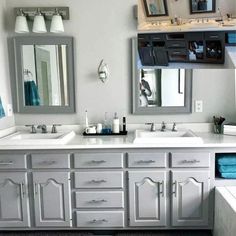 a large bathroom with two sinks and mirrors