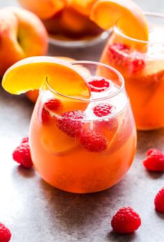 two glasses filled with orange and raspberry punch