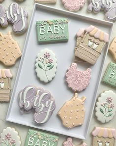 baby shower cookies are displayed in a box