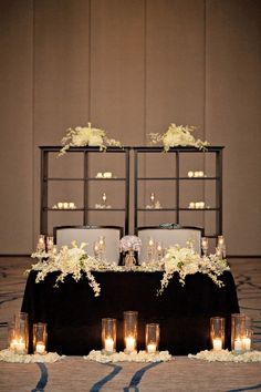 a table with candles and flowers on it