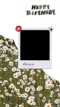 a photo frame sitting on top of a field of daisies with the words happy birthday above it